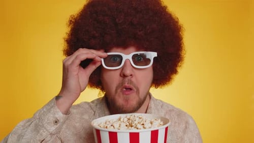 Man With Afro Eats Popcorn Wearing 3D Glasses