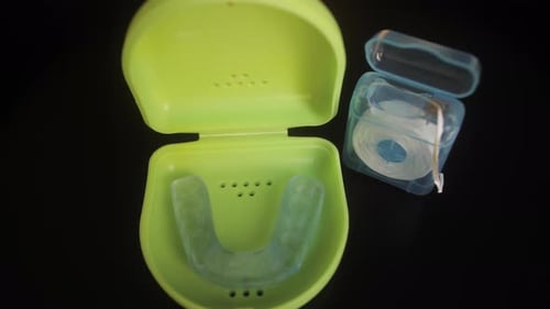 Case with Mouthguard for Teeth and Dental Floss Close Up Dental Care Concept