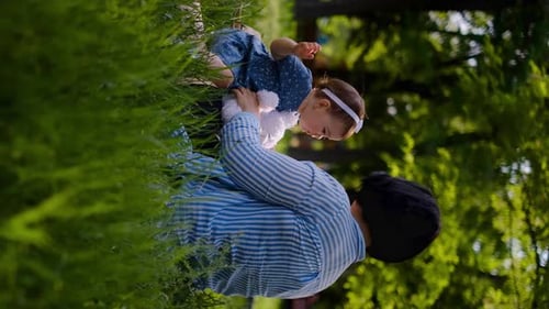 Mother and child together in the park outdoors, lying in the grass. Motherhood happiness concept. Da