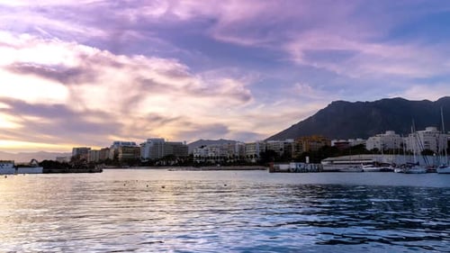 Marbella, 4k time lapse of marbella from marbella fishing port, beautiful view of moving clouds at s