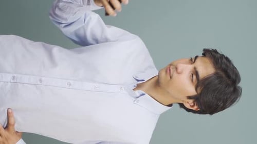 Man in Button-Down Shirt Using Smart Phone