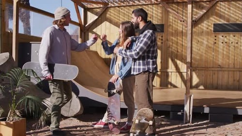 Video of happy diverse female and male skateboarders in skate park