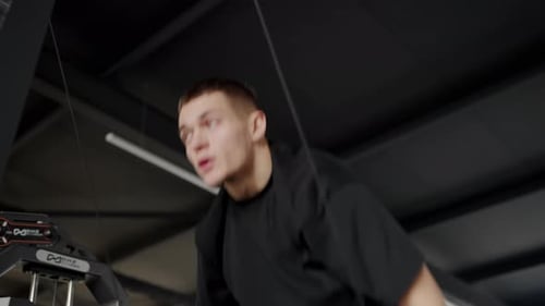 Young Man Exercising in Gym with Intense Focus and Determination