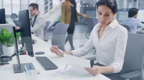 Woman working at desk in modern office setting