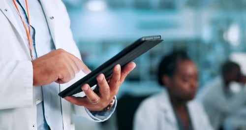 Medical Professional Using Tablet in Lab Setting