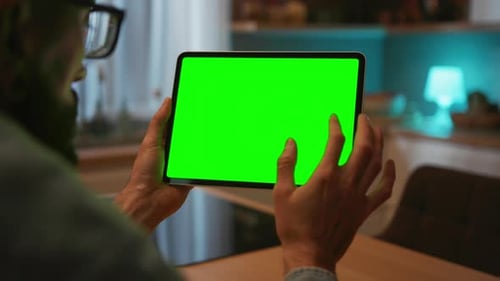 View Over Shoulder on Black Digital Tablet in Horizontal Position in Hands of Caucasian Man Guy