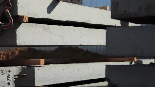 Crane Stacking Precast Concrete Slabs at Construction Site