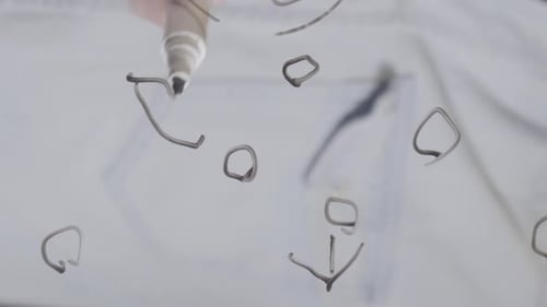 Close Up Vertical Video of Soccer Coach Explaning Game Tactics on Glass Drawing Circles and Arrows