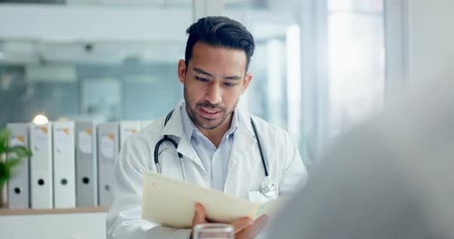Doctor Reviews Medical Report with Patient