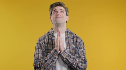 Mature 30s Man Praying Begs To Apologize Guilty Yellow Studio Hopeful Prayer