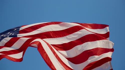 American Flag Waving Against a Blue Sky