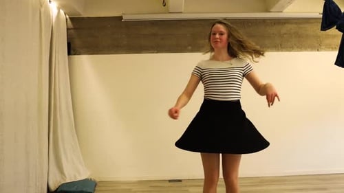 Young Adult Spinning Around Indoors