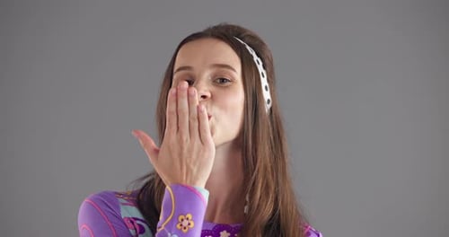 Studio, woman and face with kiss for romance, blowing and emoji gesture with expression for love