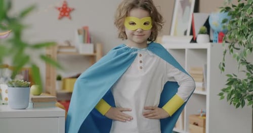 Child Poses in Superhero Costume Indoors
