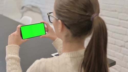 Woman Holding Phone with Green Chroma Key Screen