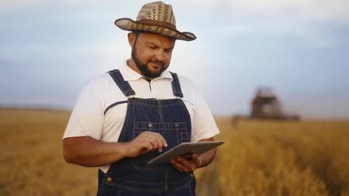 Farmer Using Tablet in Golden Wheat Field