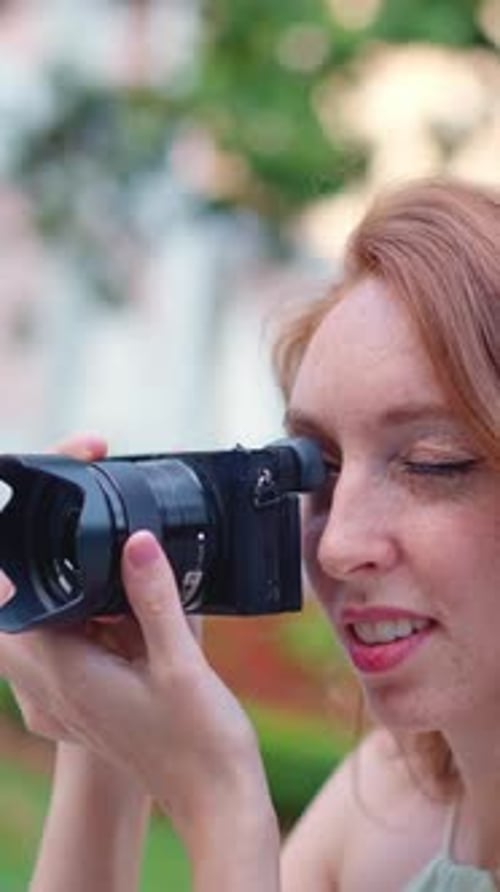 Close Up View of a Woman Taking a Photo Outdoors