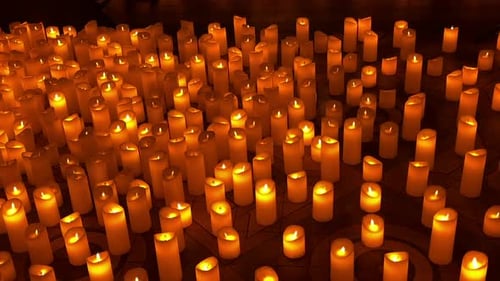 hundreds of glowing candles fill dark ceremonial hall with light