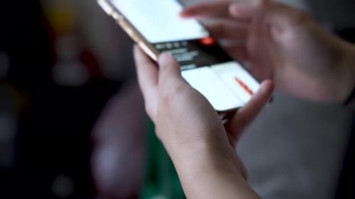 Teenager scrolling on smartphone browsing social media app