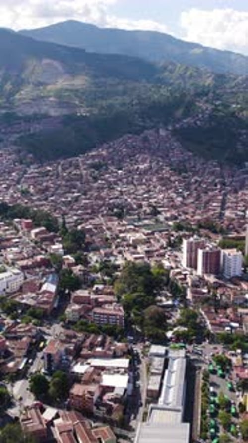 Aerial view of Comuna 13 showing colorful houses and buildings in Medellin, Colombia. Vertical Video
