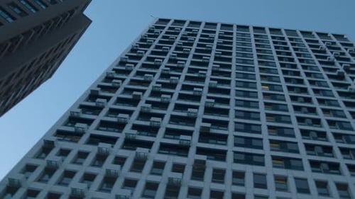 Low angle view of a multi storey building on blue sky background