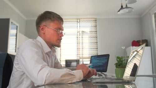 Der Teamleiter von Side View analysiert den App-Code für Datenüberprüfungen auf Laptop und Tablet