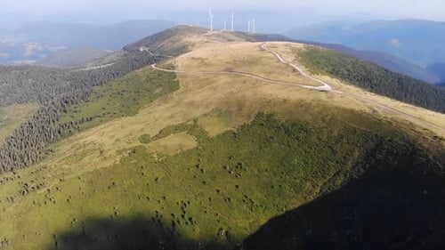 Drone Aerial of Varful Bihoru Romania Wind turbines Wind farm mountain peak green