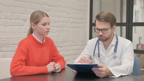 Doctor Discussing Report with Patient at Office