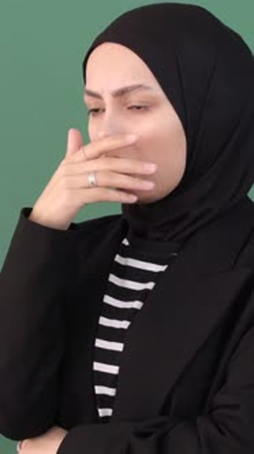 Young Adult Woman Coughing Against Green Background