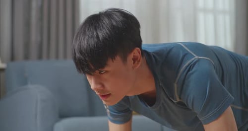 Close Up Of Fitness Asian Male Is Doing Mountain Climber Exercises In His Home