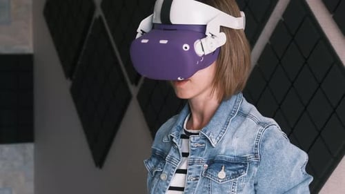 Woman Using Virtual Reality Headset and Controllers Indoors