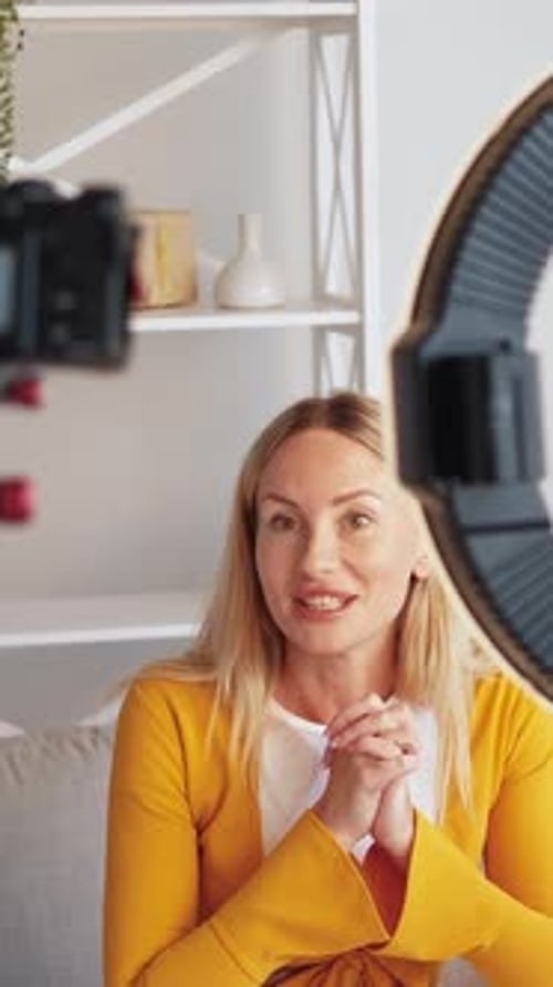 Blonde Woman Filming Video Blog Indoors