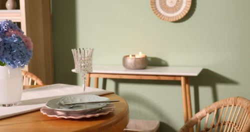 Indoor table setting with floral arrangement and candles
