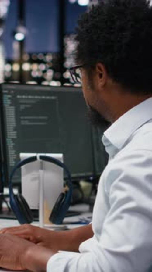 Vertical Video Engineer in Office Receiving Critical Error Warning While Writing Code