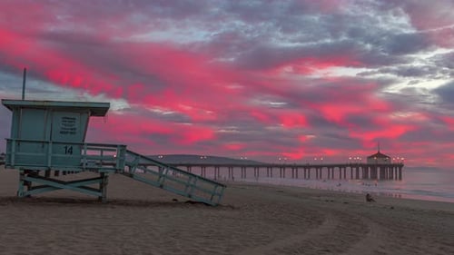 Lifeguard Tower At Manhattan Beach During Sunset With Pier In The Distance. - timelapse