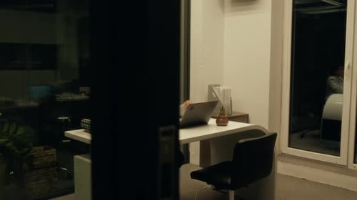 Overworked Hispanic Woman Working on Report in Dark Office at Midnight