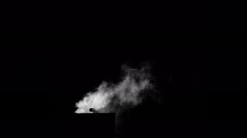 Fume Collection: Smoke being released into the atmosphere from a pipe shot on a black background, sh