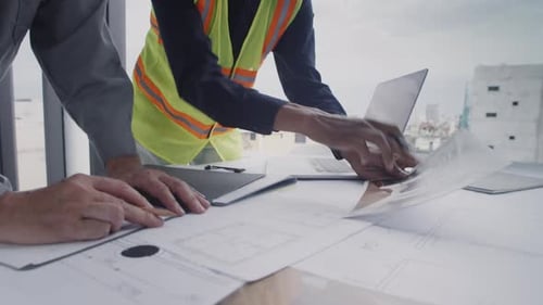 Architects Collaborate on Construction Plans in City Office