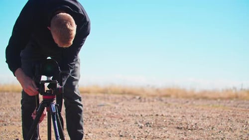 Male Photographer Filming with a Tripod, Cinematographer Outside in Colorado
