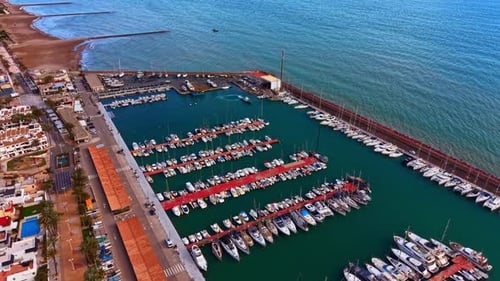 Panoramic aerial landscape of coastal town harbor and beach.