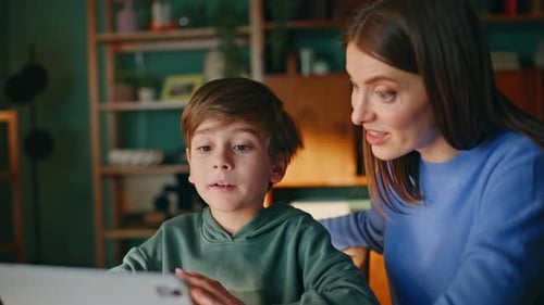 Woman and Boy Use Tablet in Cozy Home Interior