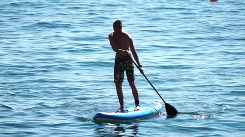Man Sup Sea Strong Athletic Man Learns to Paddle Sup Standing on Board in Open Sea Ocean on Sunny
