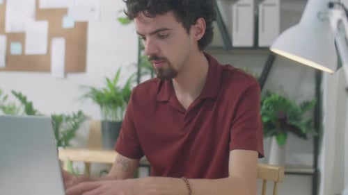 Young Businessman Working on Laptop in Office