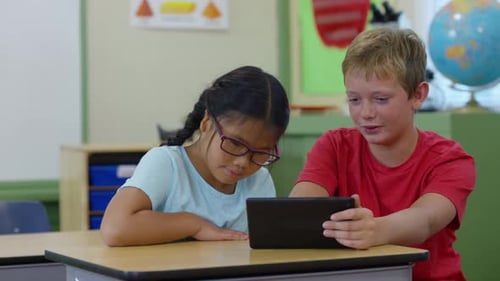 Elementary school children learning with a digital tablet in the classroom