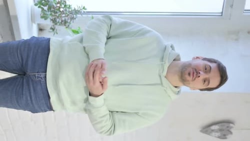 Young Adult Talking and Gesturing Indoors