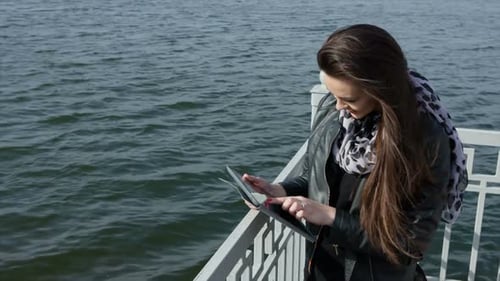 Beautiful Girl with Tablet on the Beach