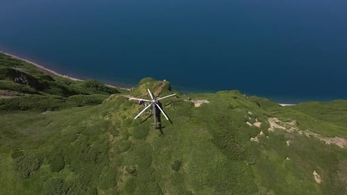AERIAL Helicopter Standing on the Edge of Krenitsyn Volcano