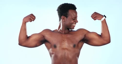 Strong, muscle and black man flexing biceps, bodybuilder in studio with portrait