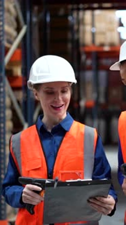 Warehouse Supervisor and Worker Checking Inventory Together