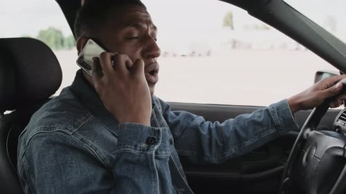 Young Adult Speaking on Phone in Car